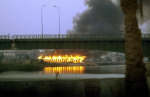 A fire rages on the north side of the Euphrates in the town of Nassariya, in central Iraq. Picture taken April 2, 2003. Reuters/Desmond Boylan