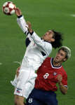 Danny Califf of the U.S. (R) watches Ivan Zamorano go up for a header. REUTERS/Kai Pfaffenbach 